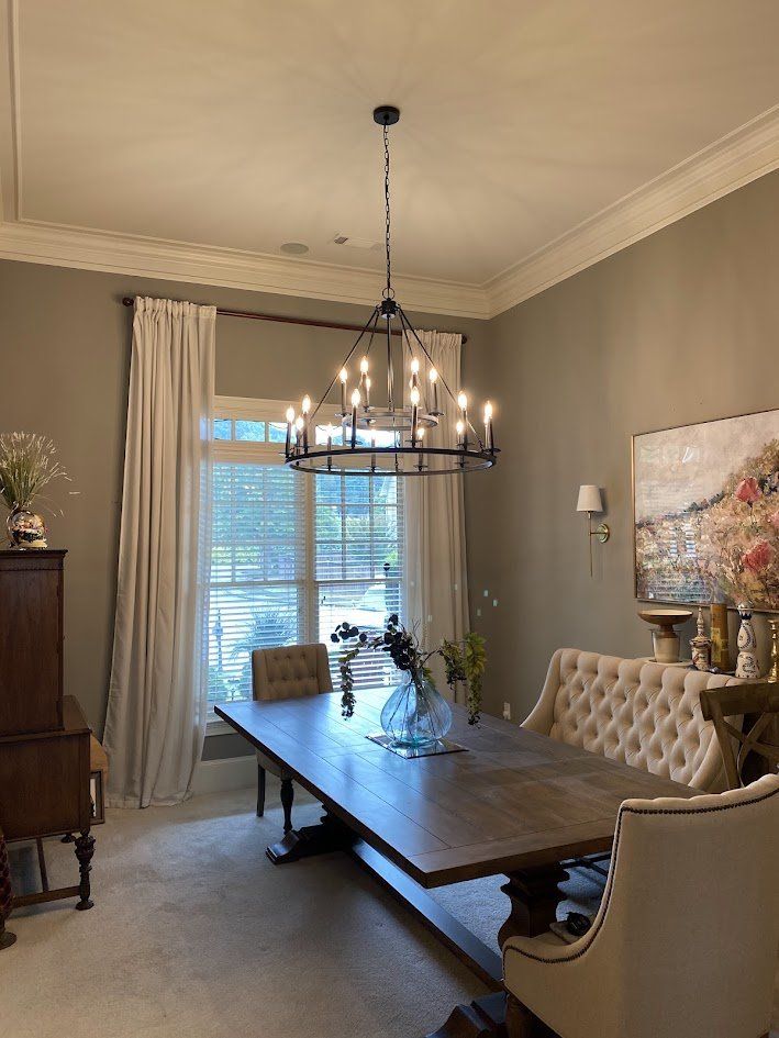 Two-tier candle chandelier centered over a dining table