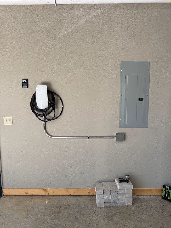 Garage EV charger installed with a clean conduit run to the panel