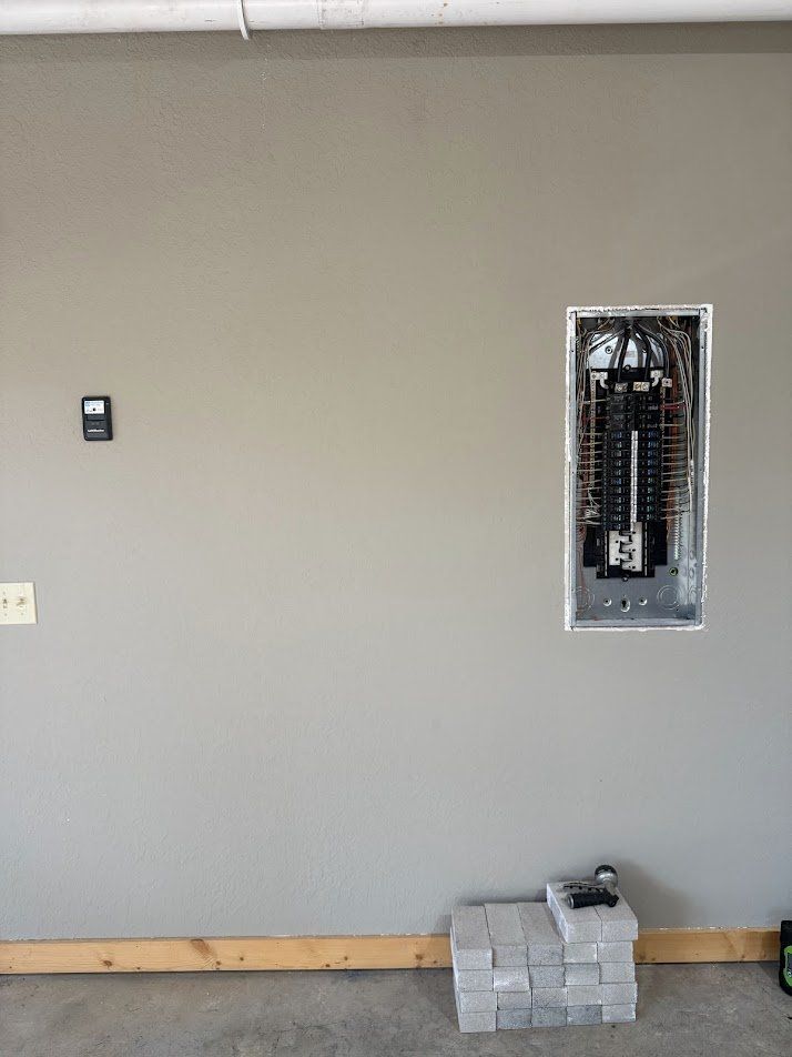 Garage wall with the panel open before the charger install