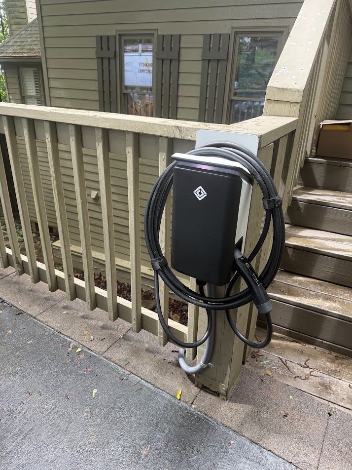 EV charger mounted on a porch railing post beside the driveway