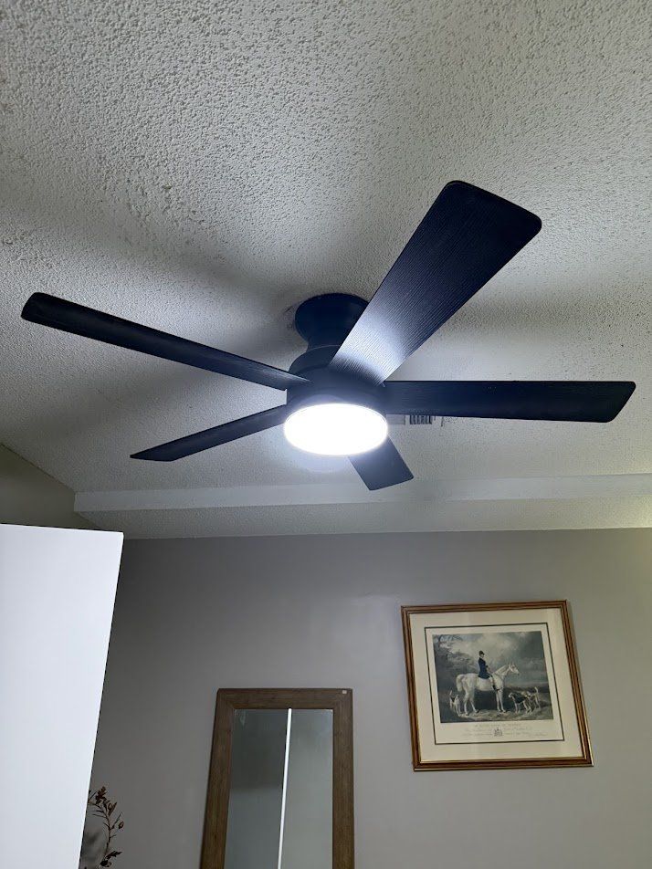 Ceiling fan securely mounted flush to the ceiling with the light working