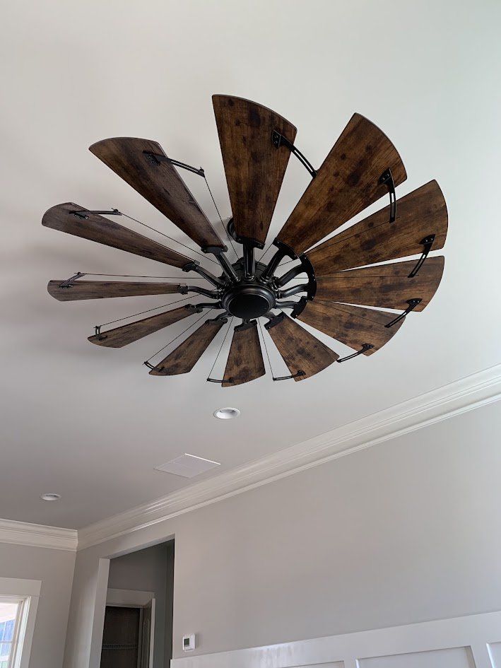 Large windmill-style ceiling fan with rustic wood blades