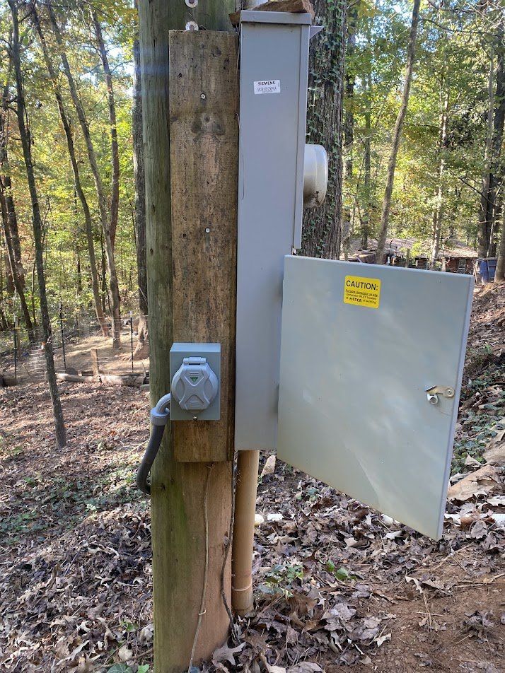 Portable generator inlet mounted on the service pole beside the meter main