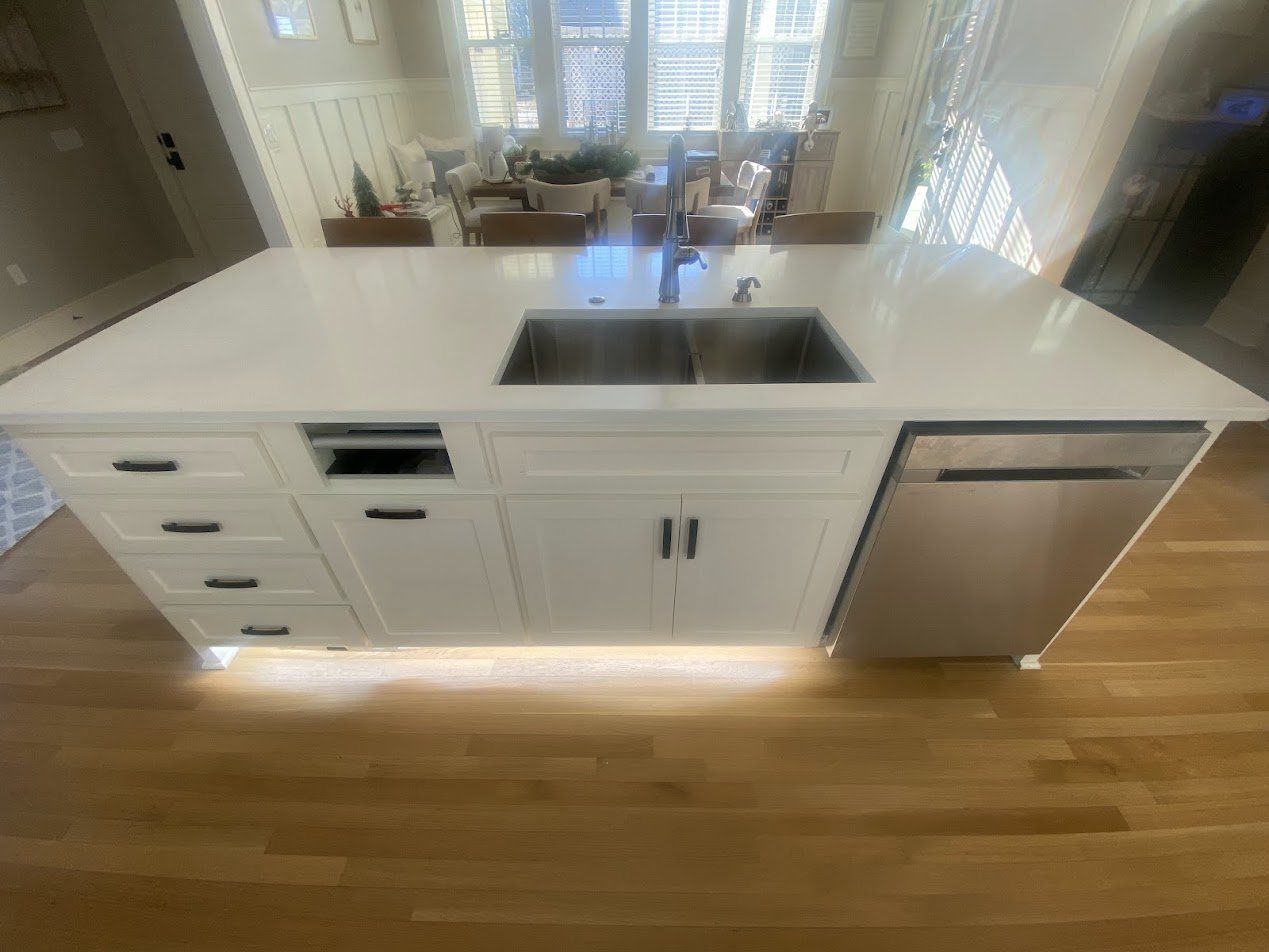 Kitchen island with soft LED toe-kick lighting along the floor