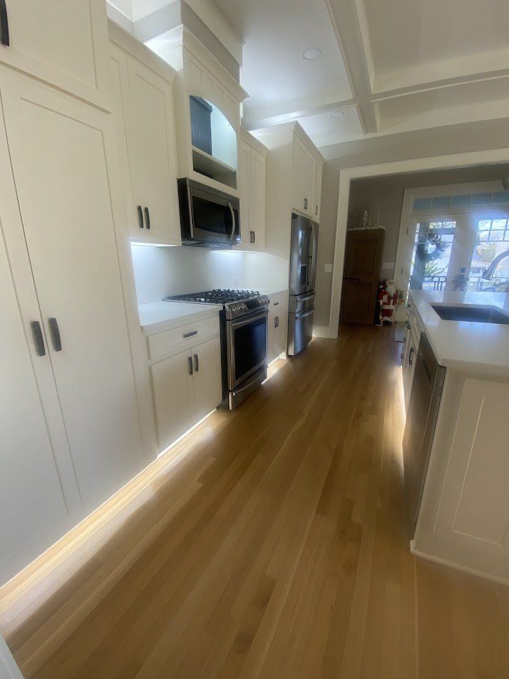 Galley view of the kitchen with toe-kick lighting along both sides