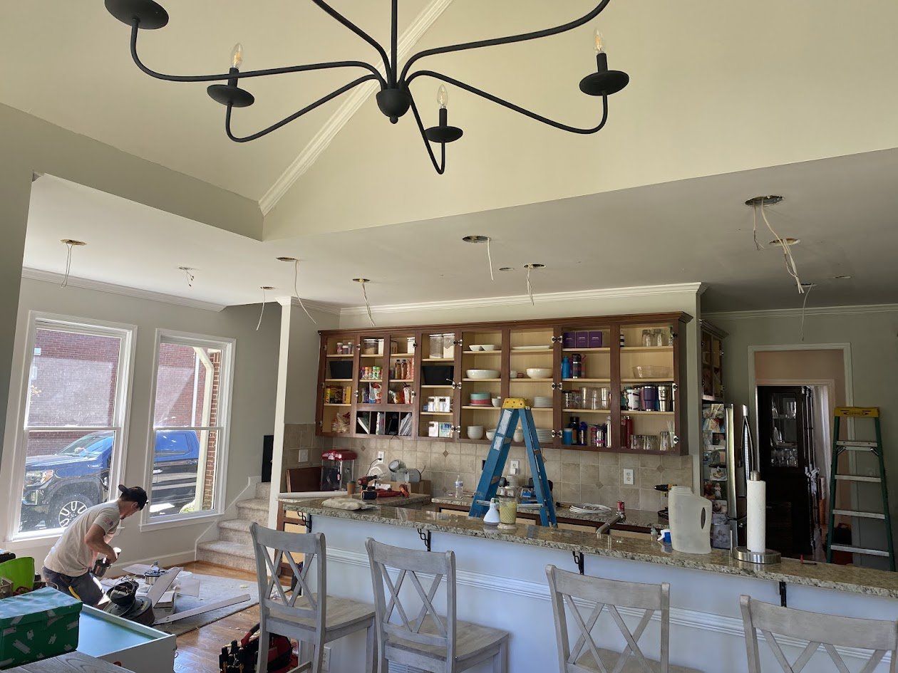 Kitchen ceiling with open recessed light cutouts and wiring before fixtures were installed