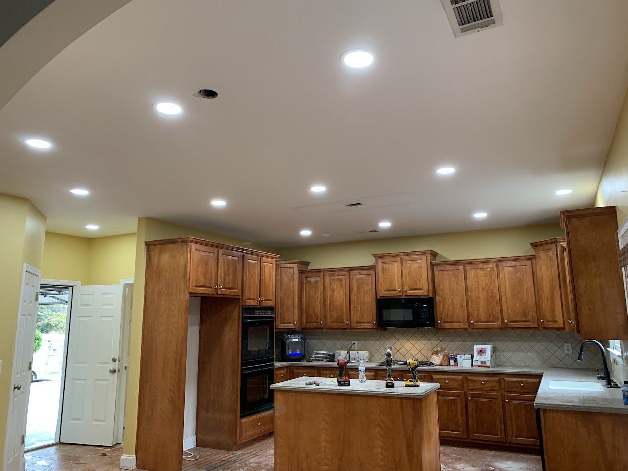 Kitchen with new recessed lights installed across the ceiling