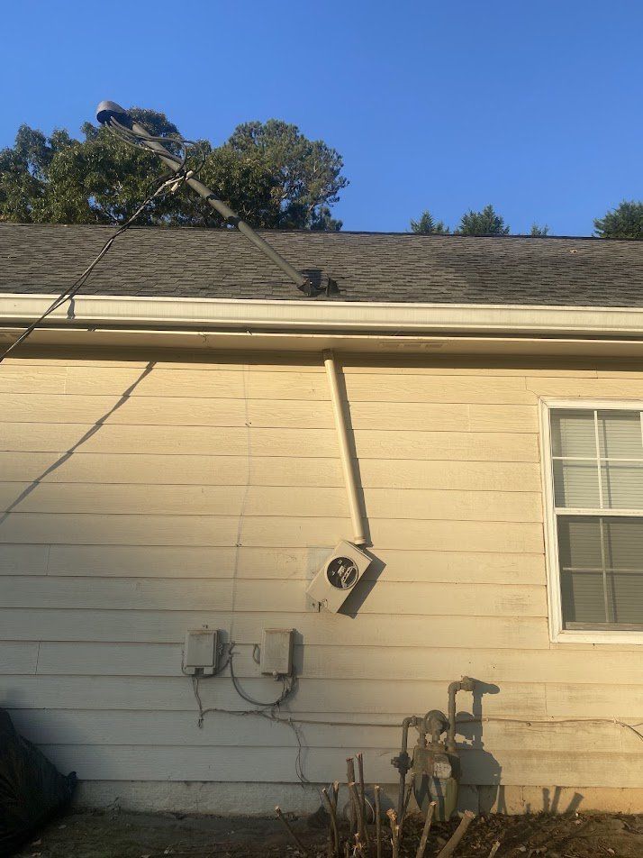 Service mast bent over the roof and meter base pulled off the siding