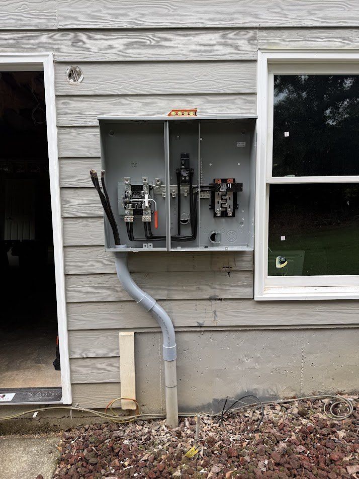 New meter and main disconnect enclosure mounted and being wired