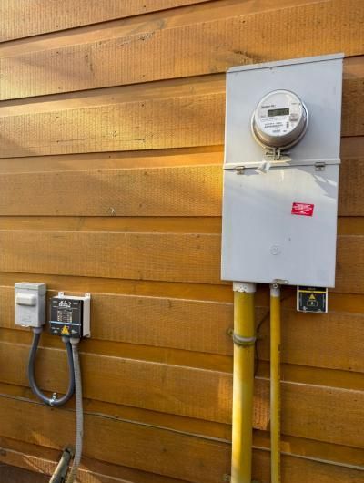 New meter and service equipment on wood siding