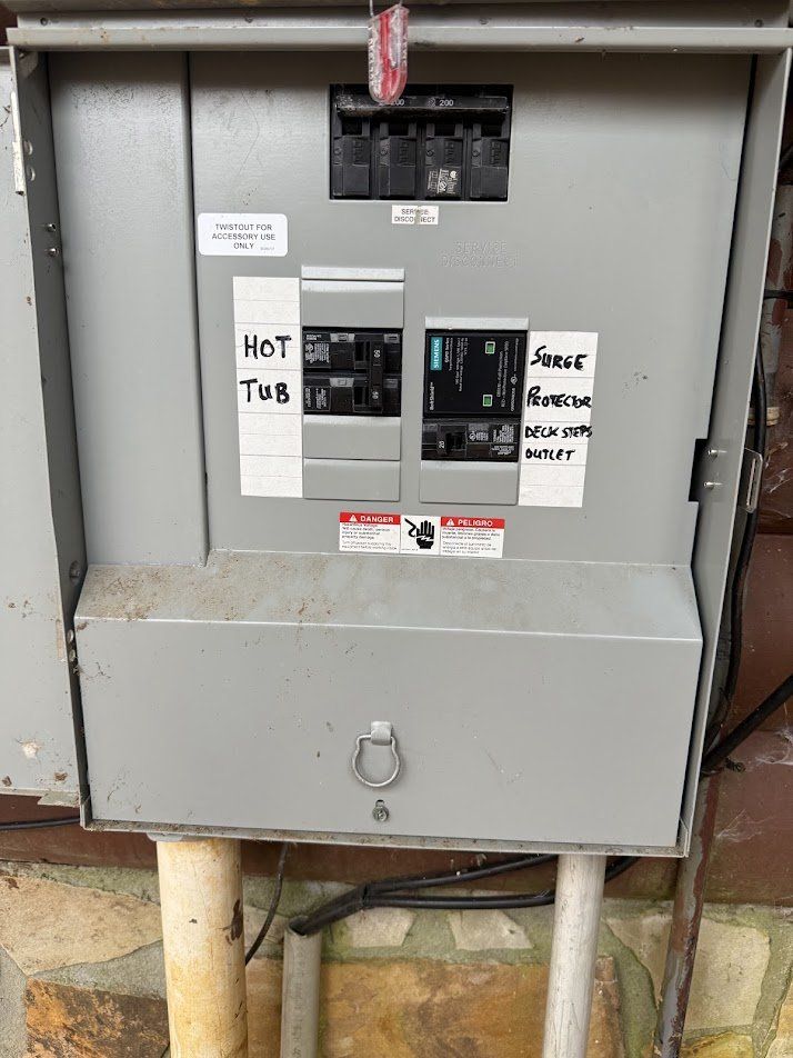 Outdoor service panel with a whole-home surge protector installed and labeled